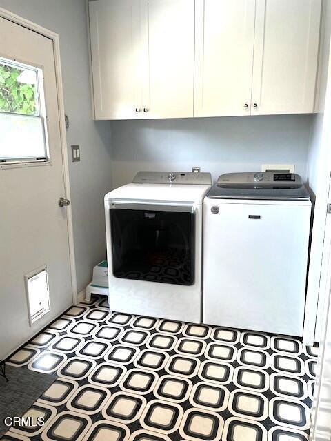 10456 Pomering Rd, Downey, CA 90241 - laundry area featuring washer and dryer and cabinet space