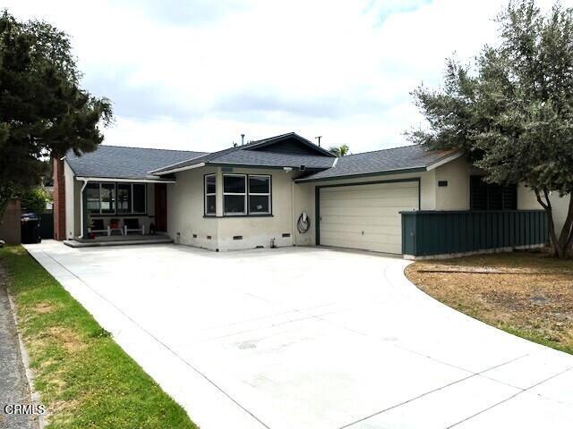 10456 Pomering Rd, Downey, CA 90241 - view of front of house with an attached garage, concrete driveway, stucco siding, and roof with shingles
