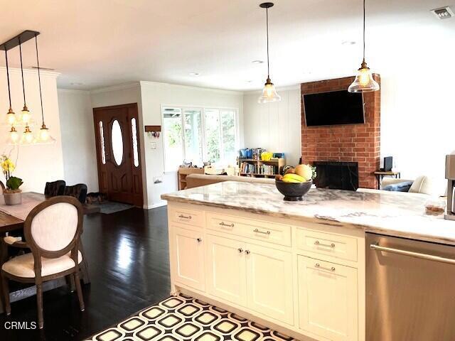 10456 Pomering Rd, Downey, CA 90241 - kitchen with dishwasher, open floor plan, a brick fireplace, crown molding, and hanging light fixtures