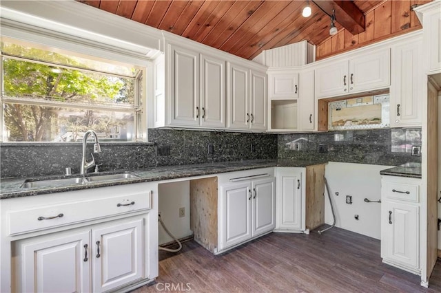 600 Moreno Ln, Sugarloaf, CA 92386 - kitchen with a sink, wood ceiling with exposed beams, backsplash, dark stone counters, and dark wood finished floors