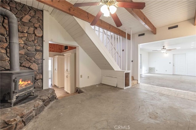 600 Moreno Ln, Sugarloaf, CA 92386 - unfurnished living room featuring a wood stove, a ceiling fan, and stairs