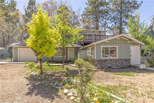 600 Moreno Ln, Sugarloaf, CA 92386 - view of property hidden behind natural elements with a garage, stone siding, and driveway