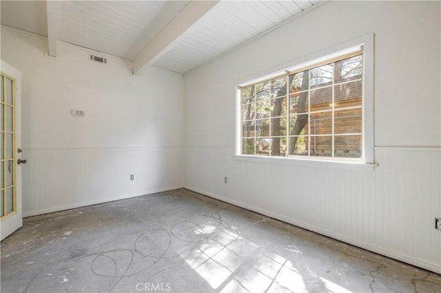 600 Moreno Ln, Sugarloaf, CA 92386 - empty room with a wainscoted wall, unfinished concrete floors, and beamed ceiling