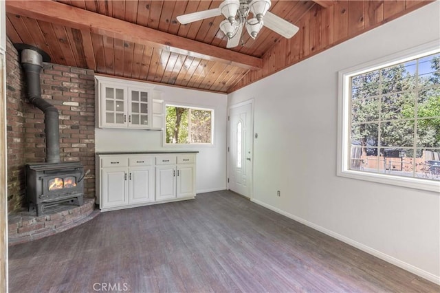 600 Moreno Ln, Sugarloaf, CA 92386 - unfurnished living room with a wood stove, dark wood finished floors, baseboards, wooden ceiling, and a ceiling fan