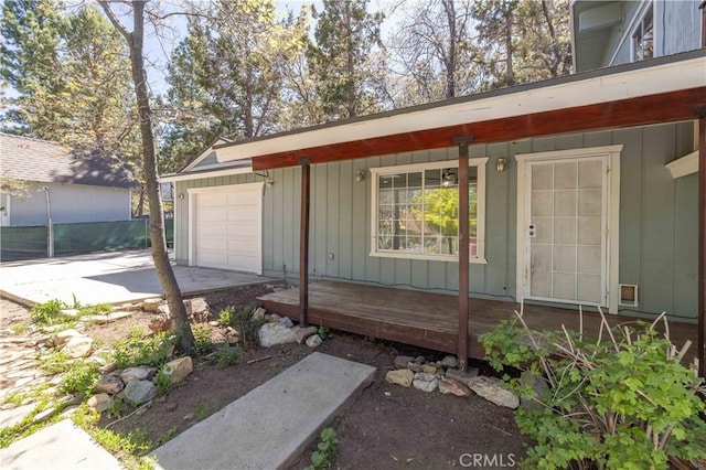 600 Moreno Ln, Sugarloaf, CA 92386 - property entrance featuring covered porch, board and batten siding, concrete driveway, and an attached garage