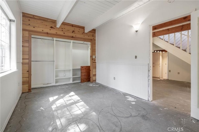 600 Moreno Ln, Sugarloaf, CA 92386 - unfurnished bedroom with wooden walls, beamed ceiling, and a closet