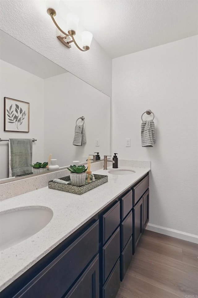 170 Montage Dr, Merced, CA 95348 - bathroom with double vanity, wood finished floors, and baseboards