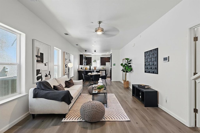 170 Montage Dr, Merced, CA 95348 - living room featuring ceiling fan, light wood-type flooring, and healthy amount of natural light