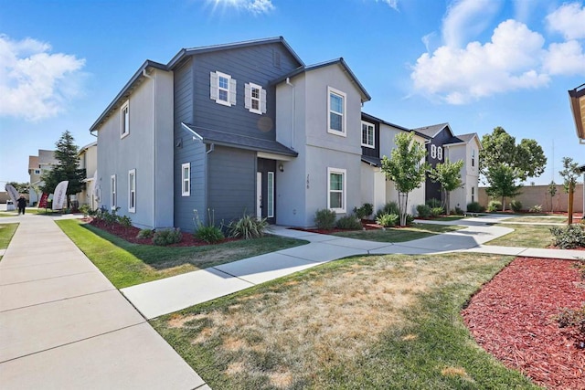 170 Montage Dr, Merced, CA 95348 - view of front facade with stucco siding, a front yard, and a residential view
