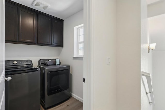 170 Montage Dr, Merced, CA 95348 - washroom with washer and clothes dryer, cabinet space, wood finished floors, and baseboards