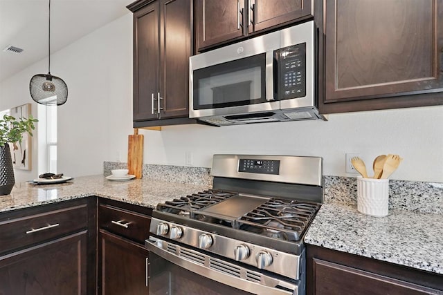 170 Montage Dr, Merced, CA 95348 - kitchen featuring stainless steel appliances, dark brown cabinets, and light stone countertops