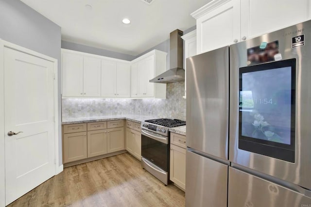 25034 Poderio Dr, Ramona, CA 92065 - kitchen with appliances with stainless steel finishes, wall chimney exhaust hood, light wood-style flooring, tasteful backsplash, and light stone counters