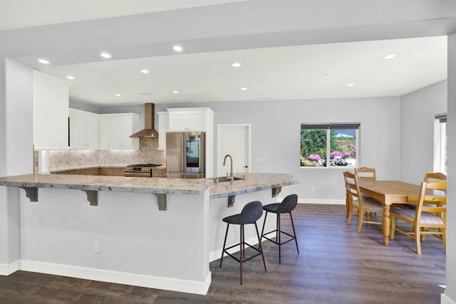 25034 Poderio Dr, Ramona, CA 92065 - kitchen featuring appliances with stainless steel finishes, baseboards, light stone countertops, a kitchen bar, and recessed lighting