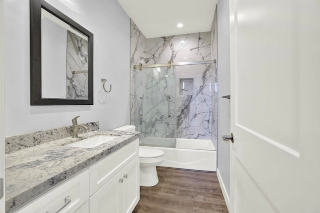 25034 Poderio Dr, Ramona, CA 92065 - bathroom with toilet, vanity, wood finished floors, shower / bath combination with glass door, and recessed lighting
