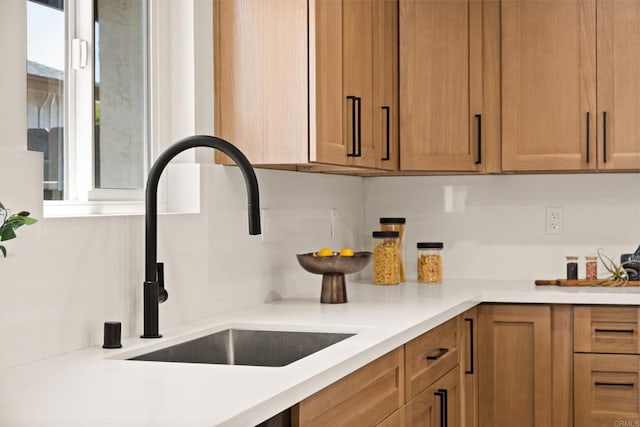 101 Coolwater Dr, San Diego, CA 92114 - kitchen with a sink, light countertops, and brown cabinetry