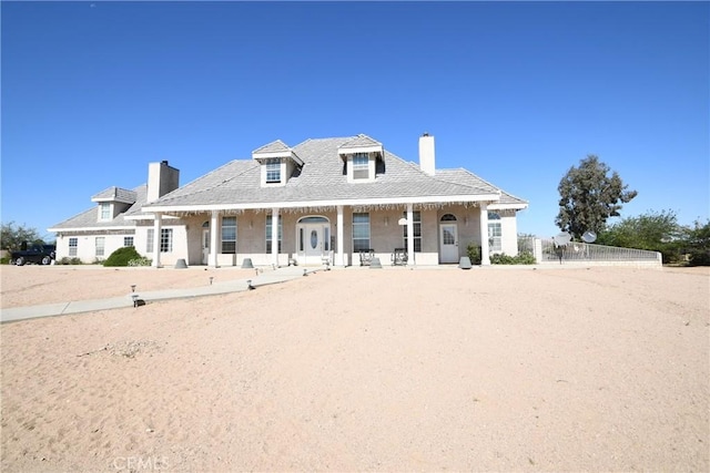 8250 Cataba Rd, Oak Hills, CA 92344 - view of front of home featuring a chimney and a porch
