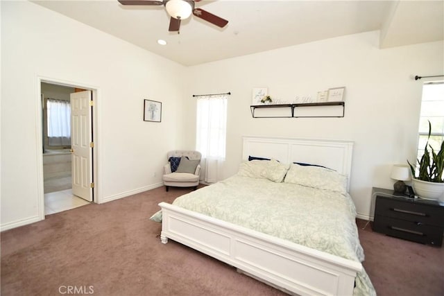 8250 Cataba Rd, Oak Hills, CA 92344 - carpeted bedroom with baseboards, ensuite bath, and ceiling fan