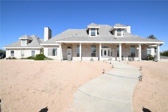 8250 Cataba Rd, Oak Hills, CA 92344 - view of front facade featuring a chimney, covered porch, and stucco siding