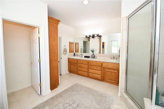 8250 Cataba Rd, Oak Hills, CA 92344 - full bath with tile patterned floors, double vanity, a shower with shower door, and baseboards