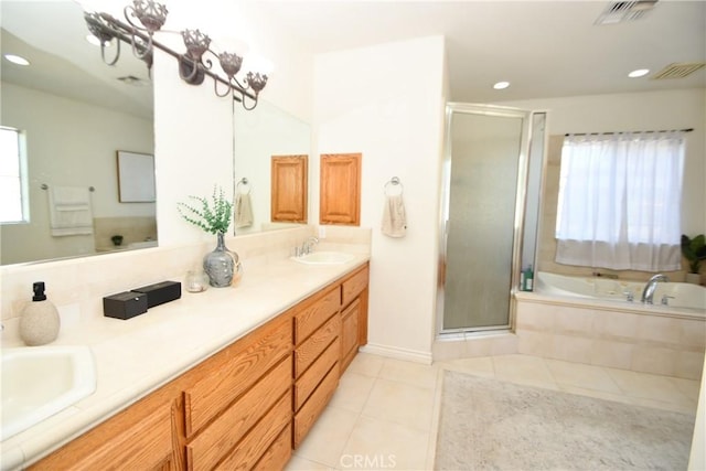 8250 Cataba Rd, Oak Hills, CA 92344 - bathroom featuring tile patterned floors, a stall shower, a garden tub, double vanity, and recessed lighting