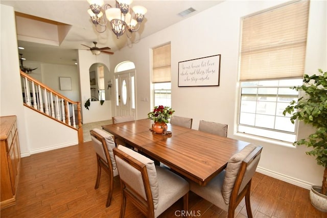 8250 Cataba Rd, Oak Hills, CA 92344 - dining area featuring wood finished floors, stairway, a ceiling fan, baseboards, and a chandelier