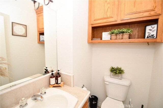 8250 Cataba Rd, Oak Hills, CA 92344 - bathroom featuring toilet and vanity