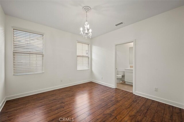 21 Land Bird, Irvine, CA 92618 - empty room featuring a chandelier, hardwood / wood-style flooring, and baseboards