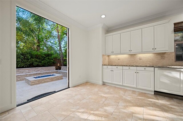 21 Land Bird, Irvine, CA 92618 - kitchen with stone countertops, backsplash, crown molding, white cabinets, and baseboards