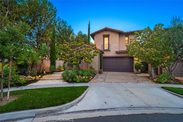 21 Land Bird, Irvine, CA 92618 - mediterranean / spanish house with driveway, stucco siding, a tiled roof, and an attached garage