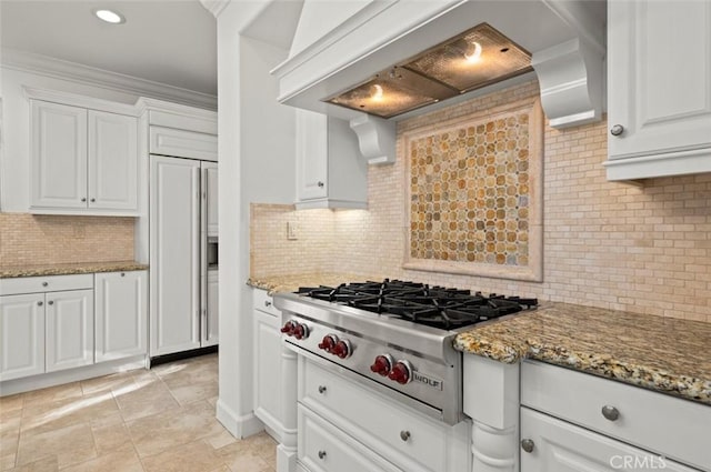 21 Land Bird, Irvine, CA 92618 - kitchen featuring paneled fridge, stainless steel gas stovetop, custom range hood, decorative backsplash, and white cabinetry