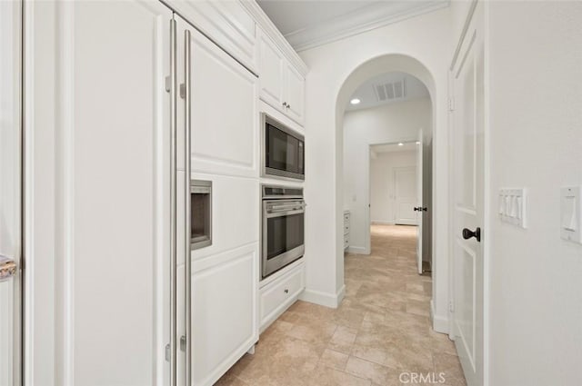21 Land Bird, Irvine, CA 92618 - kitchen with built in appliances, white cabinets, arched walkways, crown molding, and baseboards