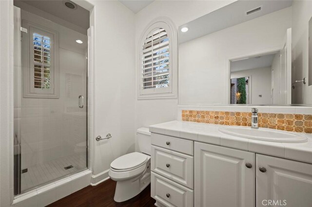 21 Land Bird, Irvine, CA 92618 - full bath featuring toilet, vanity, wood finished floors, a shower stall, and backsplash