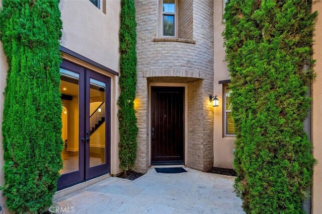 21 Land Bird, Irvine, CA 92618 - property entrance with french doors, stone siding, and stucco siding