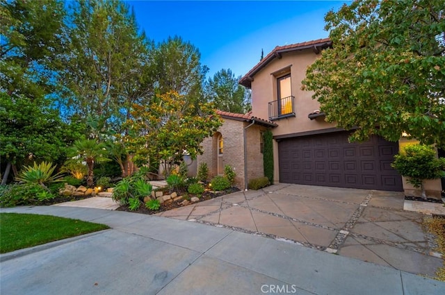 21 Land Bird, Irvine, CA 92618 - mediterranean / spanish house with a tiled roof, an attached garage, driveway, and a balcony
