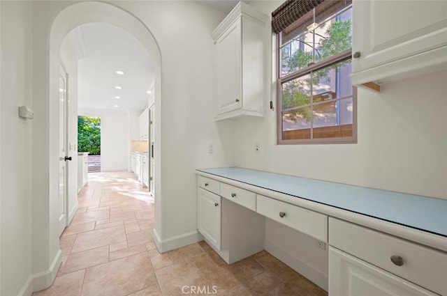 21 Land Bird, Irvine, CA 92618 - laundry room with arched walkways, baseboards, recessed lighting, and light stone finish flooring