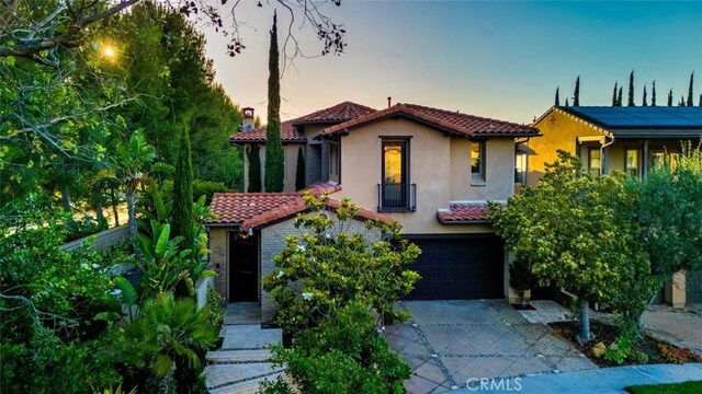 21 Land Bird, Irvine, CA 92618 - mediterranean / spanish home featuring a tiled roof, stucco siding, driveway, and an attached garage