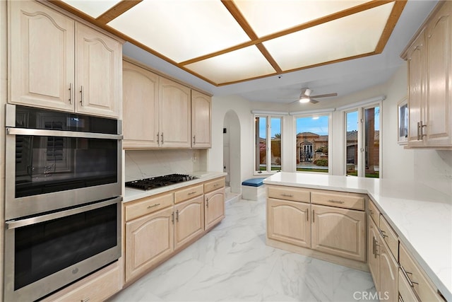 4026 Calle Lisa, San Clemente, CA 92672 - kitchen with double oven, light brown cabinetry, gas stovetop, light marble finish flooring, and arched walkways