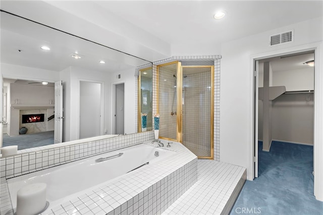 4026 Calle Lisa, San Clemente, CA 92672 - bathroom featuring a bath, a shower stall, recessed lighting, a spacious closet, and a high end fireplace