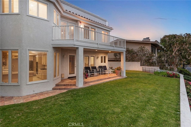 4026 Calle Lisa, San Clemente, CA 92672 - back of house at dusk featuring a balcony, stucco siding, and a patio