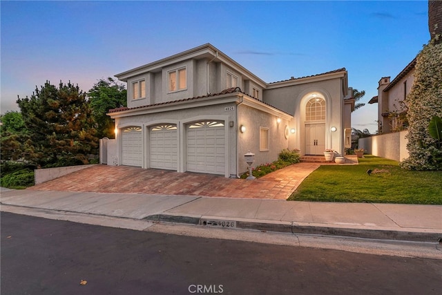 4026 Calle Lisa, San Clemente, CA 92672 - mediterranean / spanish home featuring an attached garage, a front yard, stucco siding, decorative driveway, and a tiled roof