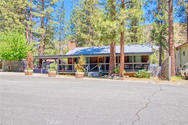 5726 Lodgepole Dr, Wrightwood, CA 92397 - view of front facade with a porch and a chimney