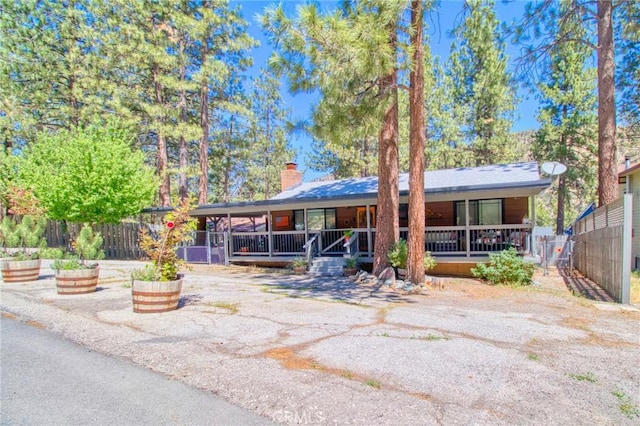 5726 Lodgepole Dr, Wrightwood, CA 92397 - ranch-style house featuring a porch and a chimney
