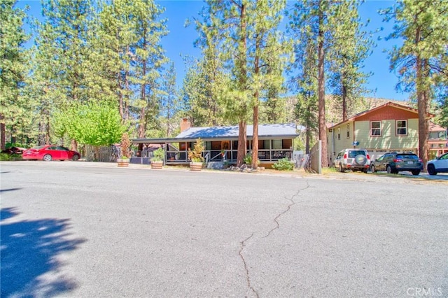 5726 Lodgepole Dr, Wrightwood, CA 92397 - view of front facade with a chimney and covered porch