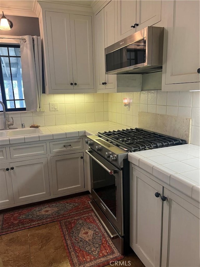 5726 Lodgepole Dr, Wrightwood, CA 92397 - kitchen with appliances with stainless steel finishes, tile countertops, a sink, and decorative backsplash