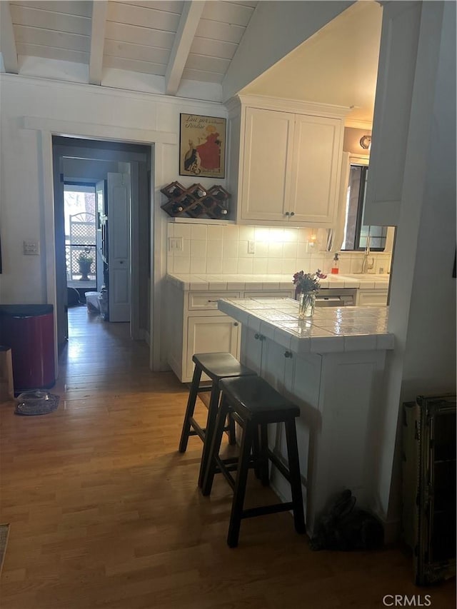 5726 Lodgepole Dr, Wrightwood, CA 92397 - kitchen featuring tile countertops, wood finished floors, and white cabinets