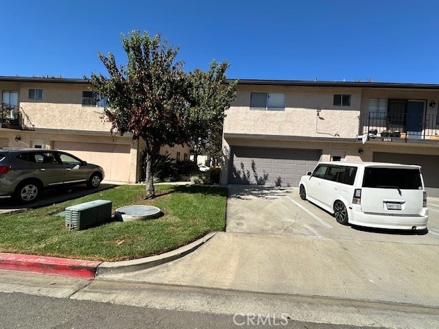 2070 Avenida Placida Unit 3, Simi Valley, CA 93063 - multi unit property featuring concrete driveway, stucco siding, an attached garage, a front lawn, and a balcony