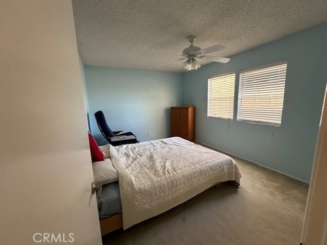 2070 Avenida Placida Unit 3, Simi Valley, CA 93063 - carpeted bedroom featuring a textured ceiling, a ceiling fan, and baseboards
