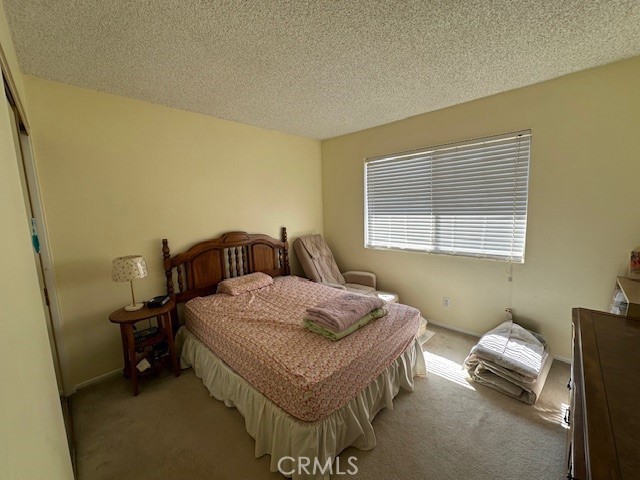 2070 Avenida Placida Unit 3, Simi Valley, CA 93063 - bedroom featuring light carpet and a textured ceiling