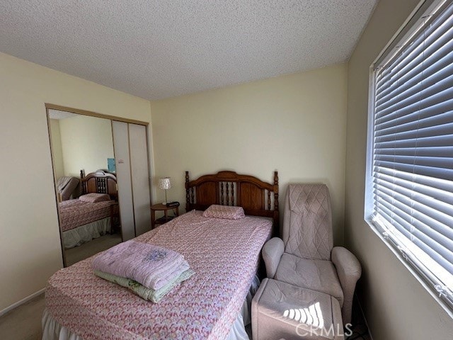 2070 Avenida Placida Unit 3, Simi Valley, CA 93063 - bedroom featuring a textured ceiling, a closet, and carpet floors
