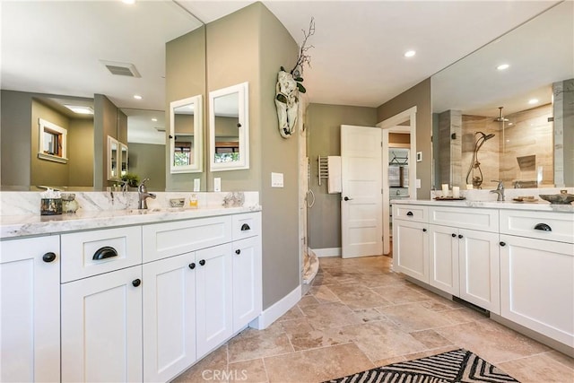 923 Lake Edge Way, Lake Arrowhead, CA 92352 - full bath featuring a shower stall, two vanities, baseboards, recessed lighting, and stone finish floors